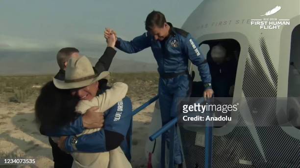 Jeff Bezos along with his brother Mark Bezos, 18-year-old Oliver Daemen, and 82-year-old Wally Funk leave Blue Originâs New Shepard crew capsule...