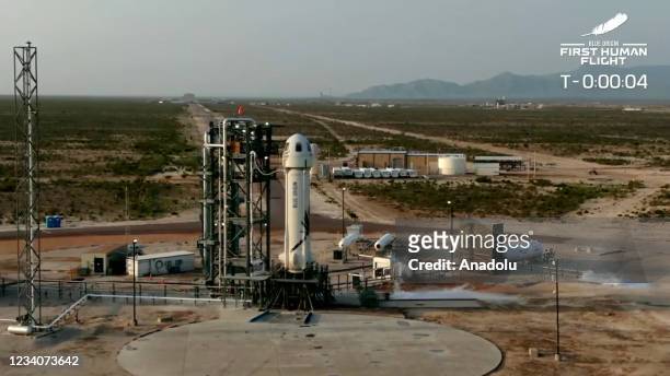 The New Shepard Blue Origin rocket prepares to lift-off from the launch pad carrying Jeff Bezos along with his brother Mark Bezos, 18-year-old Oliver...