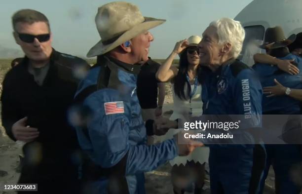 Jeff Bezos along with his brother Mark Bezos, 18-year-old Oliver Daemen, and 82-year-old Wally Funk leave Blue Originâs New Shepard crew capsule...