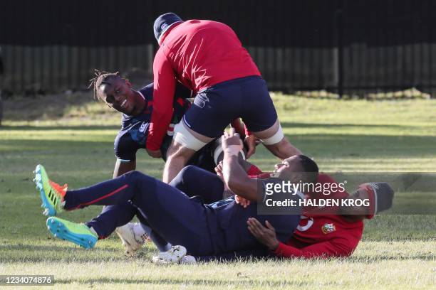 British and Irish Lions' lock Maro Itoje and teammates take part in a training session at The Hermanus High School on the outskirts of Cape Town on...