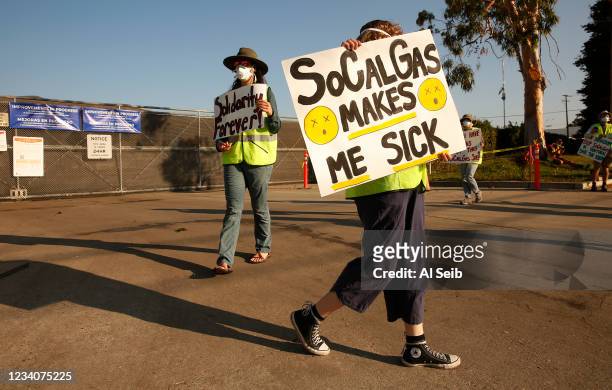Emmma Aist right, and Alexandra Nagy, left, join the environmental groups Food and Water Watch and the Westside Clean Air Coalition as they marched...