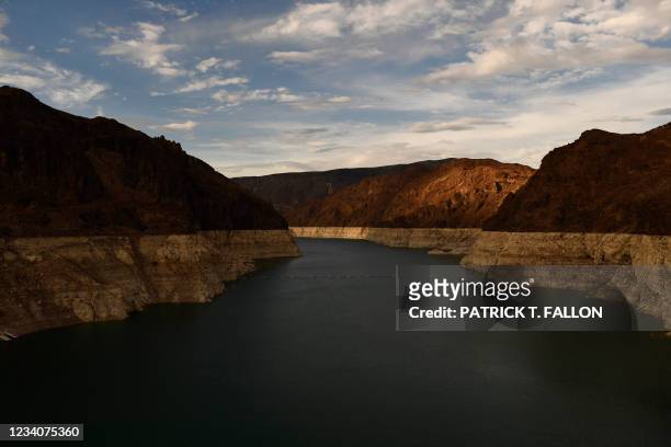 Bathtub ring" is visible at sunset during low water levels the Lake Mead reservoir due to the western drought on July 19, 2021 as seen from the...