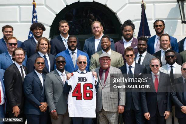 President Joe Biden holds a jersey alongside Tampa Bay Buccaneers head coach Bruce Arians and quarterback Tom Brady during a ceremony honoring the...