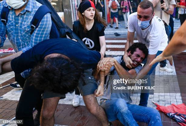 Police officers detain protesters during a rally, in the Kadikoy district, in Istanbul, on July 20 called to mark on the anniversary of the 2015...