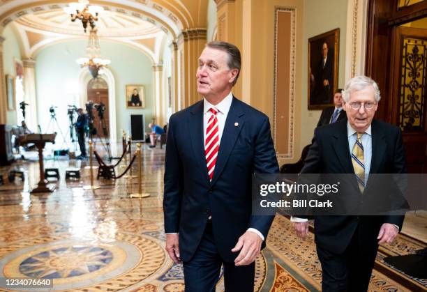 Former Sen. David Perdue, R-Ga., left, and Senate Minority Leader Mitch McConnell, R-Ky., walk through the Ohio Clock Corridor in the Capitol on...