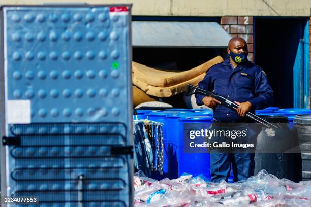 Police go door to door to confiscate suspected looted goods at Mansel Market in the Central Business District on July 19, 2021 in Durban, South...