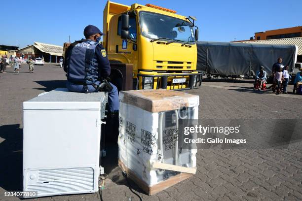 Police confiscate suspected looted goods at Mansel Market in the Central Business District on July 19, 2021 in Durban, South Africa. This comes after...