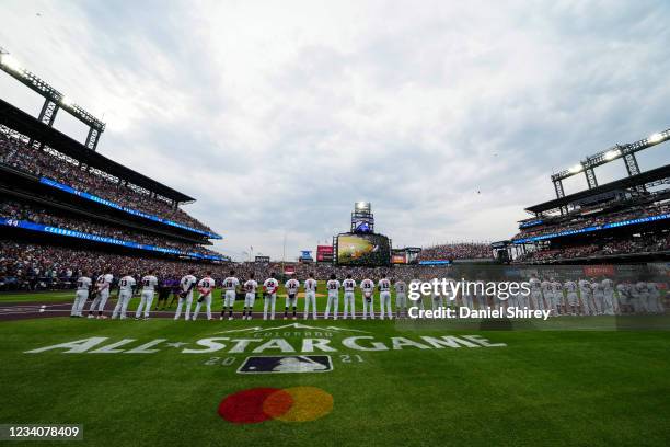 National League players look on during a tribute to Hank Aaron before the 91st MLB All-Star Game presented by Mastercard at Coors Field on Tuesday,...
