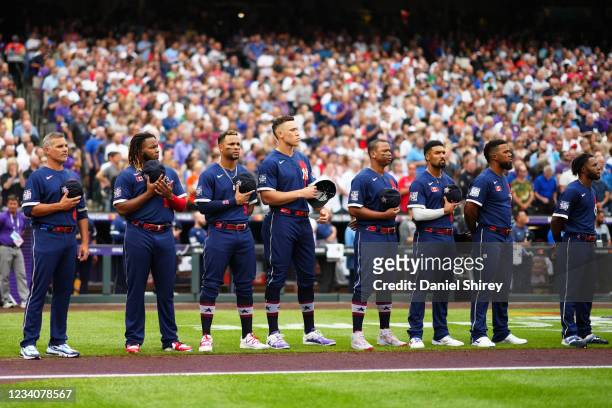 American League players line the base paths during the Canadian national anthem before the 91st MLB All-Star Game presented by Mastercard at Coors...