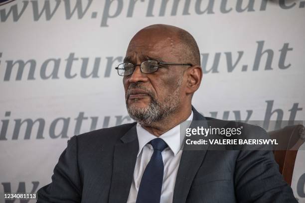 Designated Prime Minister Ariel Henry looks on during a ceremony at La Primature in Port-au-Prince, Haiti, on July 20, 2021. - The ceremony comes as...