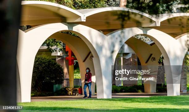 Masked student walks under the iconic arches at UC Riverside on July 2021 in Riverside California. The UC system has announced that it will require...