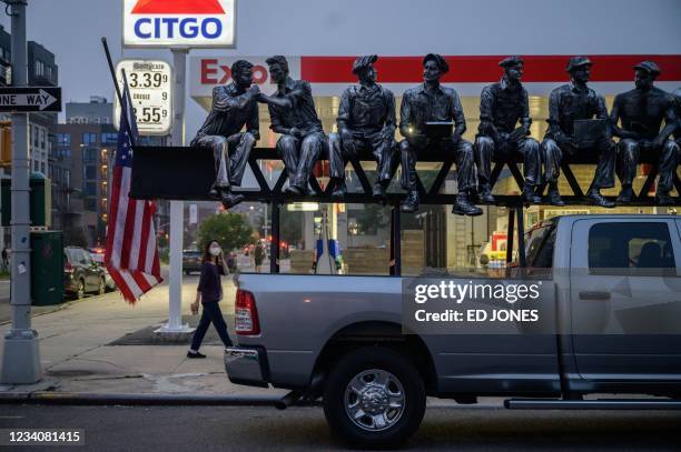 Truck carrying a sculpture of the famous photograph entitled 'Lunch atop a Skyscraper' sits parked outside a petrol station in the Brooklyn borough...