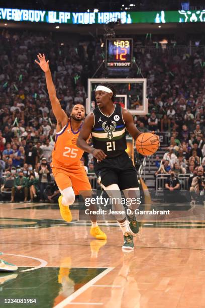 Jrue Holiday of the Milwaukee Bucks handles the ball against the Phoenix Suns during Game Six of the 2021 NBA Finals on July 20, 2021 at Fiserv Forum...