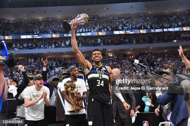 Giannis Antetokounmpo of the Milwaukee Bucks celebrates after receiving the Bill Russell Finals MVP Award after winning Game Six of the 2021 NBA...