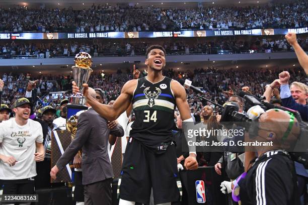Giannis Antetokounmpo of the Milwaukee Bucks celebrates after receiving the Bill Russell Finals MVP Award after winning Game Six of the 2021 NBA...