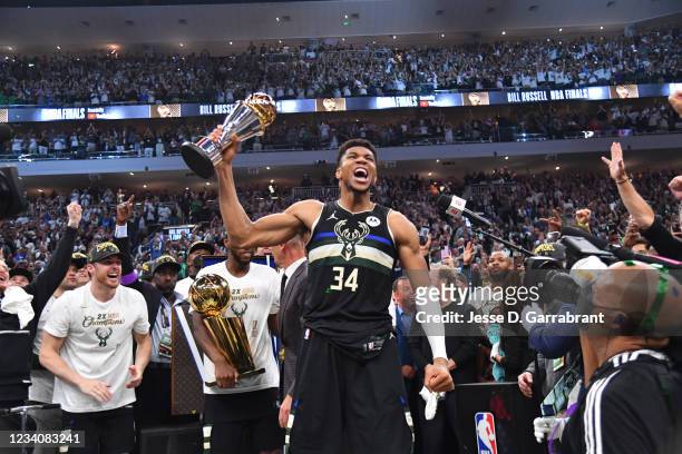 Giannis Antetokounmpo of the Milwaukee Bucks celebrates after receiving the Bill Russell Finals MVP Award after winning Game Six of the 2021 NBA...