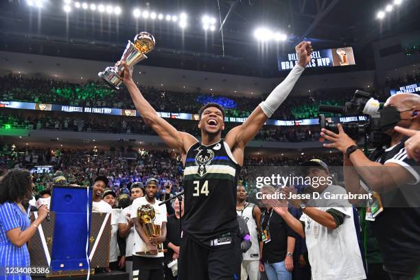 Giannis Antetokounmpo of the Milwaukee Bucks celebrates after receiving the Bill Russell Finals MVP Award after winning Game Six of the 2021 NBA...