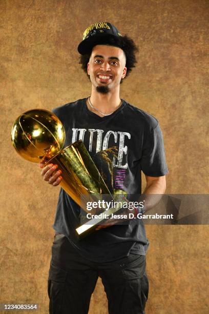 Jordan Nwora of the Milwaukee Bucks poses for a portrait with the Larry O'Brien Trophy after winning Game Six of the 2021 NBA Finals against the...