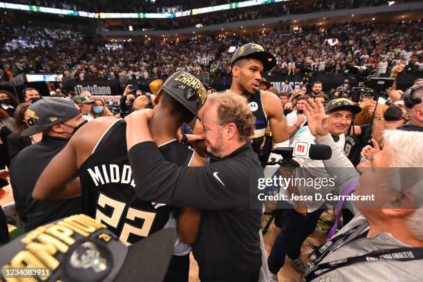 Khris Middleton of the Milwaukee Bucks and Head Coach Mike Budenholzer of the Milwaukee Bucks celebrate after winning Game Six of the 2021 NBA Finals...