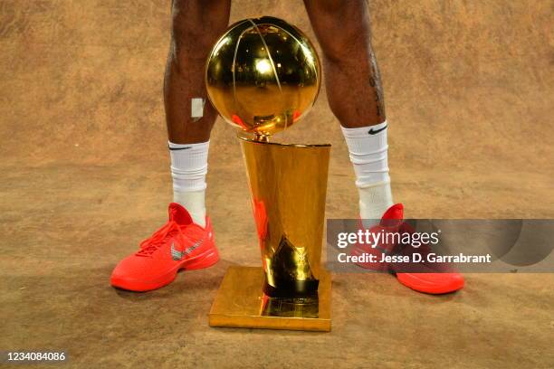 The sneakers of P.J. Tucker of the Milwaukee Bucks are seen with the Larry O'Brien Trophy after winning Game Six of the 2021 NBA Finals against the...