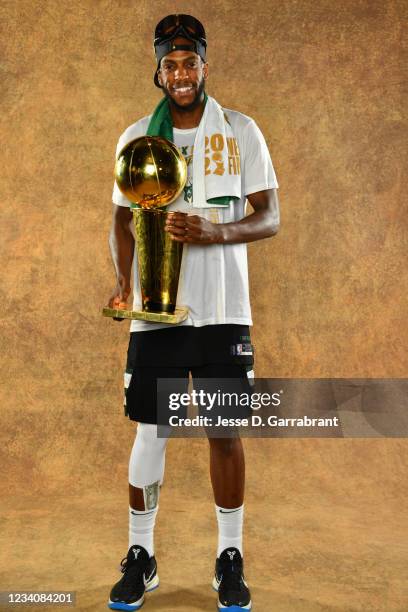 Khris Middleton of the Milwaukee Bucks poses for a portrait with the Larry O'Brien Trophy after winning Game Six of the 2021 NBA Finals against the...