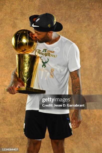 Tucker of the Milwaukee Bucks poses for a portrait with the Larry O'Brien Trophy after winning Game Six of the 2021 NBA Finals against the Phoenix...