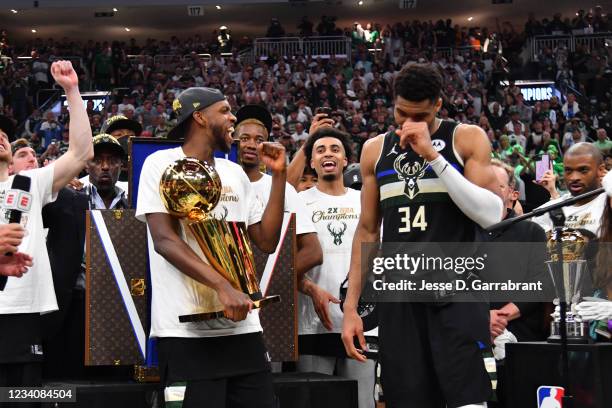 Khris Middleton of the Milwaukee Bucks and Giannis Antetokounmpo of the Milwaukee Bucks celebrate with the Larry O'Brien Trophy after winning Game...