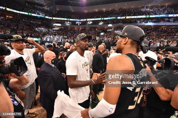 Giannis Antetokounmpo of the Milwaukee Bucks and Bobby Portis of the Milwaukee Bucks high-five after winning Game Six of the 2021 NBA Finals against...