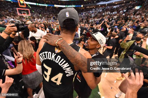 Giannis Antetokounmpo of the Milwaukee Bucks hugs Former NBA Player, Brandon Jennings after winning Game Six of the 2021 NBA Finals against the...