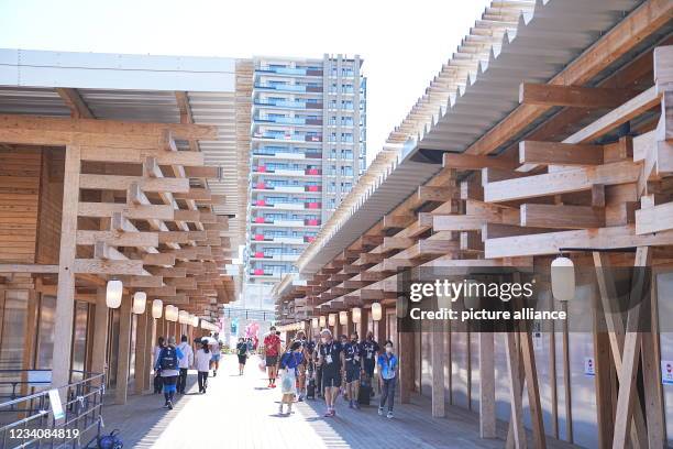 July 2021, Japan, Tokio: Athletes walk through the Olympic Village. The Olympic Village is a housing development that will house the participants of...