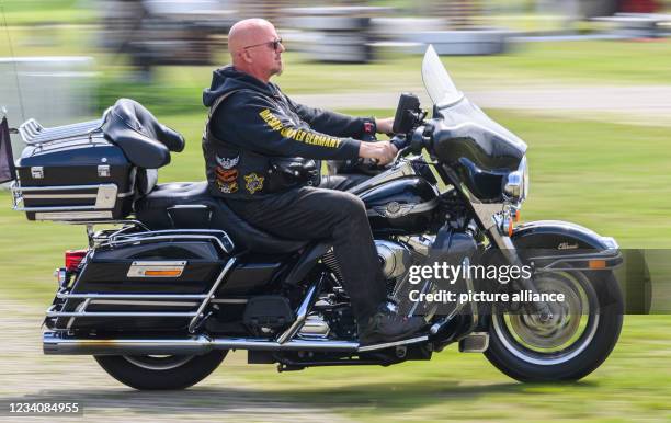 July 2021, Saxony, Dresden: A member of the Dresden Harley Davidson Club, "Dresden Chapter Germany Harley Owners Group", rides his Harley along the...