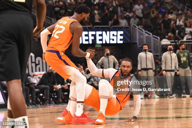 Deandre Ayton of the Phoenix Suns helps up Jae Crowder of the Phoenix Suns during Game Six of the 2021 NBA Finals on July 20, 2021 at Fiserv Forum in...