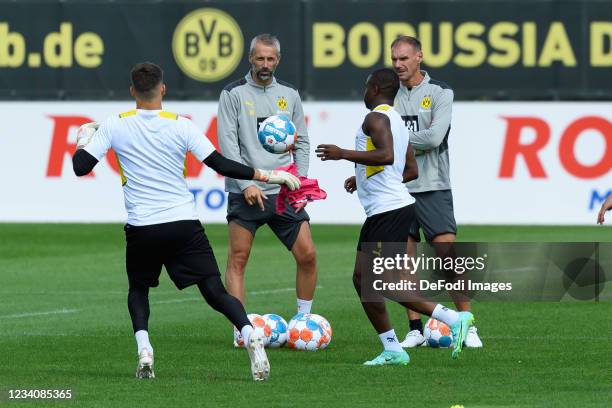 Head coach Marco Rose of Borussia Dortmund and assistant coach Alexander Zickler of Borussia Dortmund look on during the training session of Borussia...