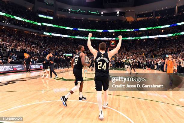 Khris Middleton of the Milwaukee Bucks and Pat Connaughton of the Milwaukee Bucks react after winning Game Six of the 2021 NBA Finals against the...