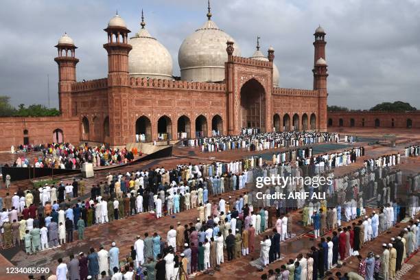 Muslim devotees offer prayers at the historical Badshahi Mosque during the Eid al-Adha or the 'Festival of Sacrifice, in Lahore on July 21, 2021.