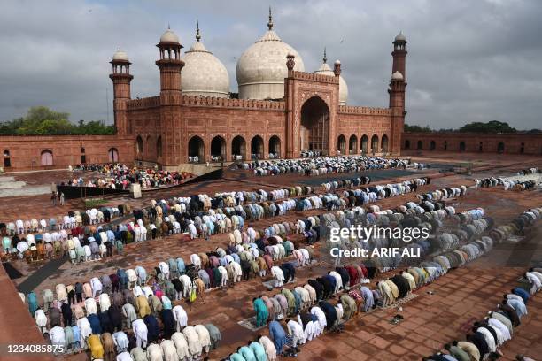 Muslim devotees offer prayers at the historical Badshahi Mosque during the Eid al-Adha or the 'Festival of Sacrifice, in Lahore on July 21, 2021.