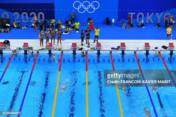 An overview shows athletes as they take part in a practice session in the swimming pool at the Tokyo Aquatics Centre, ahead of the Tokyo 2020 Olympic...