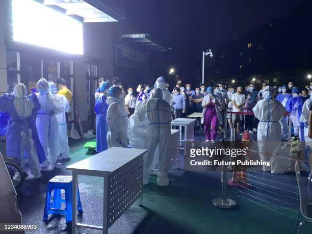 Medical workers prepare an emergent coronavirus test for residents living near the international airport in Nanjing in east China&#039;s Jiangsu...