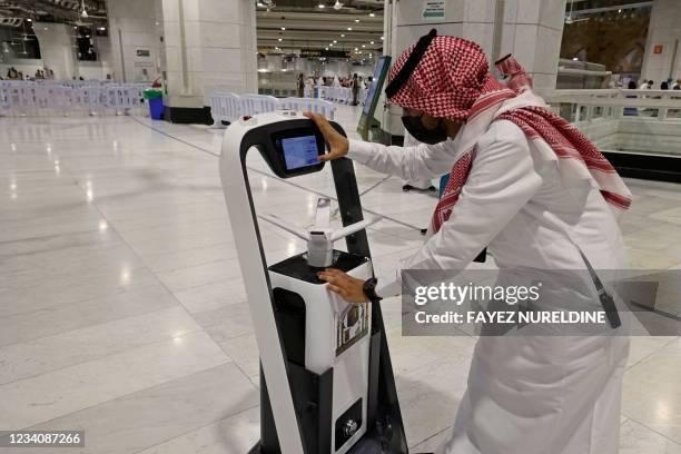 Saudi staff works on a smart sterilising robot at the Grand Mosque in Saudi Arabia's holy city of Mecca, during the yearly hajj pilgrimage amid the...