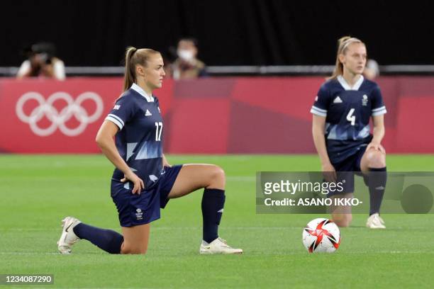 Britain's forward Georgia Stanway and Britain's midfielder Keira Walsh take a knee before the Tokyo 2020 Olympic Games women's group E first round...