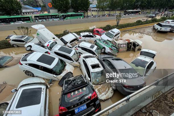 Cars sit in floodwaters after heavy rains hit the city of Zhengzhou in China's central Henan province on July 21, 2021. - - China OUT / China OUT
