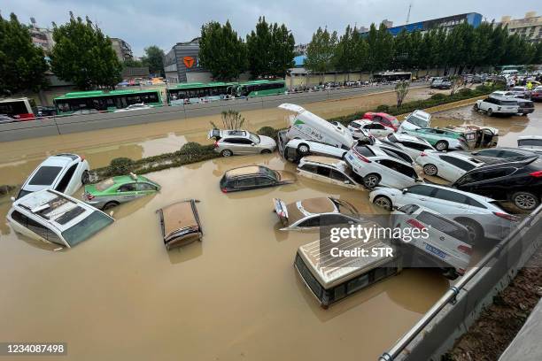 Cars sit in floodwaters after heavy rains hit the city of Zhengzhou in China's central Henan province on July 21, 2021. - - China OUT / China OUT