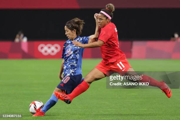 Japan's forward Mana Iwabuchi vies with Canada's midfielder Desiree Scott during the Tokyo 2020 Olympic Games women's group E first round football...