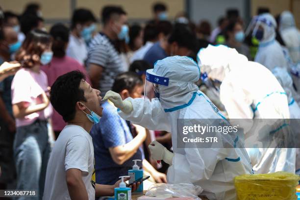 Resident receives nucleic acid test for the Covid-19 coronavirus in Nanjing, in eastern Jiangsu province on July 21, 2021. - China OUT / China OUT