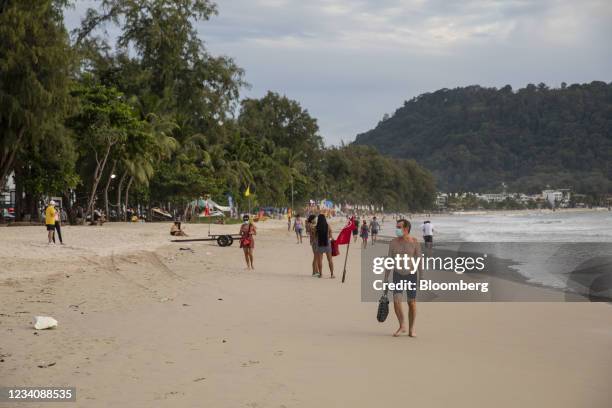 Tourists, some wearing protective masks, at a near-empty Patong Beach in Patong, Phuket, Thailand, on Monday, July 19, 2021. In a precursor to the...