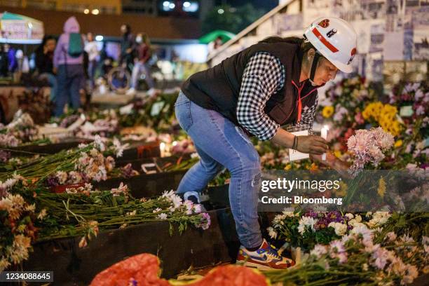 Demonstrators pay tribute at the floral arrangements in honor of those who were killed during the national strike at the Monument to the Heroes...