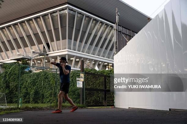 Nishimoto Seiho, a local resident, practices boxing outside Tokyo Aquatics Centre, a venue for swimming, diving and artistic swimming at the upcoming...
