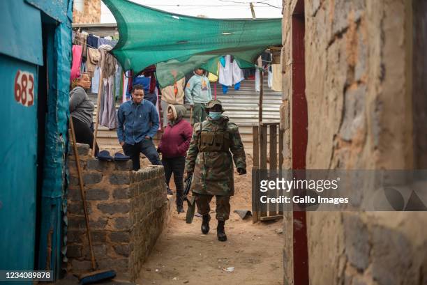 Member looking for looted goods during on operation by South African Police Service and South African National Defence Force to recover looted goods...