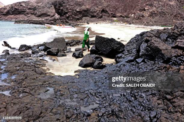 An oil contaminated beach is pictured after a tanker sank off the coast of Yemen's southern port city of Aden on July 21, 2021.