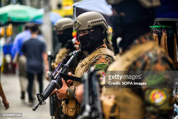 Soldiers stand on guard before the search operation for gang members in street markets, plazas and public transportation. The army incorporated 1046...